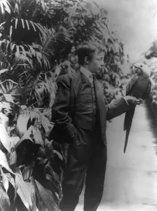 Theodore Roosevelt & "Eli Yale" blue macaw, c1902 June 17. Creator: Frances Benjamin Johnston