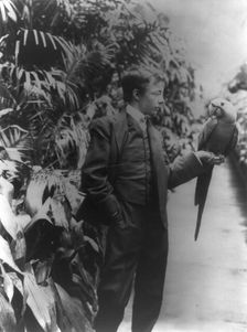 Theodore Roosevelt & "Eli Yale" blue macaw, c1902 June 17. Creator: Frances Benjamin Johnston