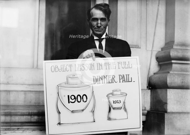 Theron Akin, Rep. from New York; with 'Full Dinner Pail' Placard, 1913. Creator: Harris & Ewing.