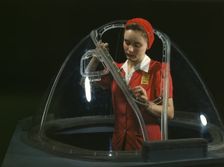 This girl in a glass house is putting finishing touches..., Long Beach, Calif. , 1942. Creator: Alfred T Palmer