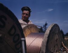 This husky member of a construction crew building a new 33,000-volt..., Fort Knox, Ky., 1942. Creator: Alfred T Palmer
