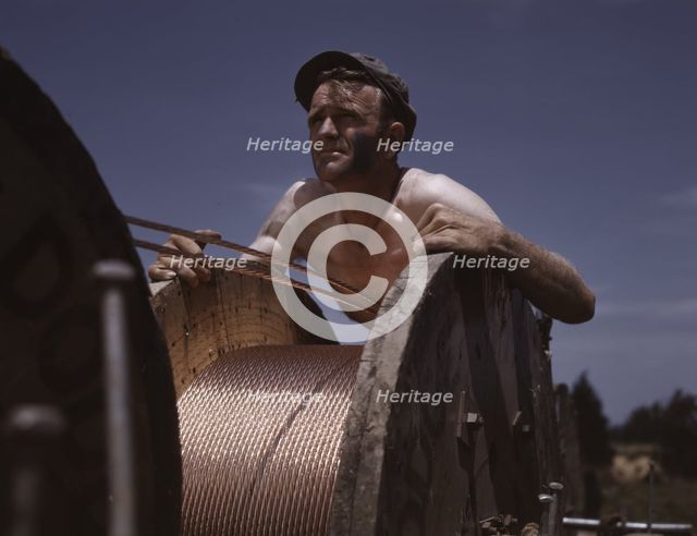 This husky member of a construction crew building a new 33,000-volt electric..., Ft. Knox, Ky., 1942 Creator: Alfred T Palmer.
