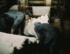 This sheet of synthetic rubber coming off the rolling mill...B.F. Goodrich Co., Akron, Ohio, 1941. Creator: Alfred T Palmer