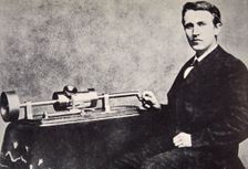 Thomas Alva Edison sitting beside his invention, the phonograph, 1878. Creator: Unknown