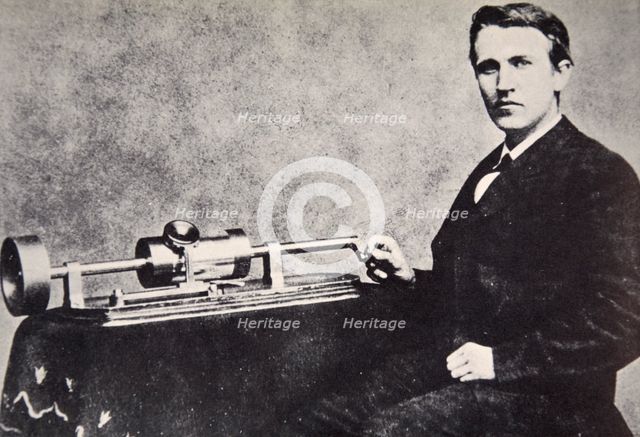 Thomas Alva Edison sitting beside his invention, the phonograph, 1878.  Creator: Unknown.