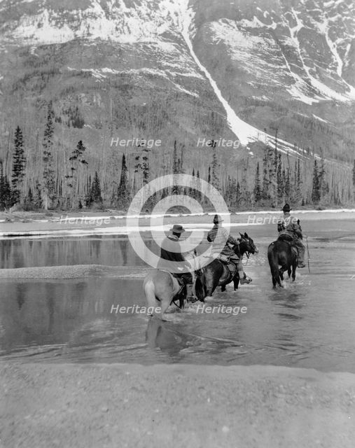 Three campers on horseback cross the Columbia River in Washington, 1903. Creator: Frances Benjamin Johnston.