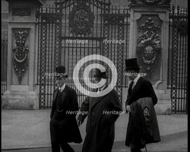 Three British Male Members of Parliament Walking Away from Buckingham Palace, 1924. Creator: British Pathe Ltd.