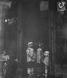 Three girls standing in a doorway, Chinatown, San Francisco, between 1896 and 1906. Creator: Arnold Genthe