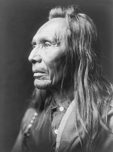 Three Eagles, a Nez Percé Indian, head-and-shoulders portrait, facing left, c1910. Creator: Edward Sheriff Curtis