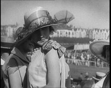Three Female Civilians Wearing Smart Summer Outfits and Hats Chatting at the Horse Race, 1920. Creator: British Pathe Ltd