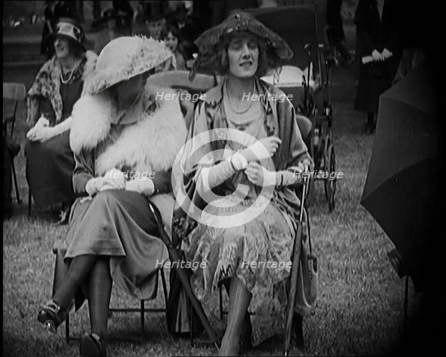 Three Female Civilians Seating Outdoors Wearing Evening Outfits and Hats, 1920. Creator: British Pathe Ltd.