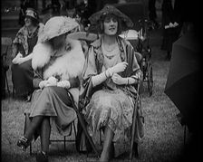 Three Female Civilians Seating Outdoors Wearing Evening Outfits and Hats, 1920. Creator: British Pathe Ltd
