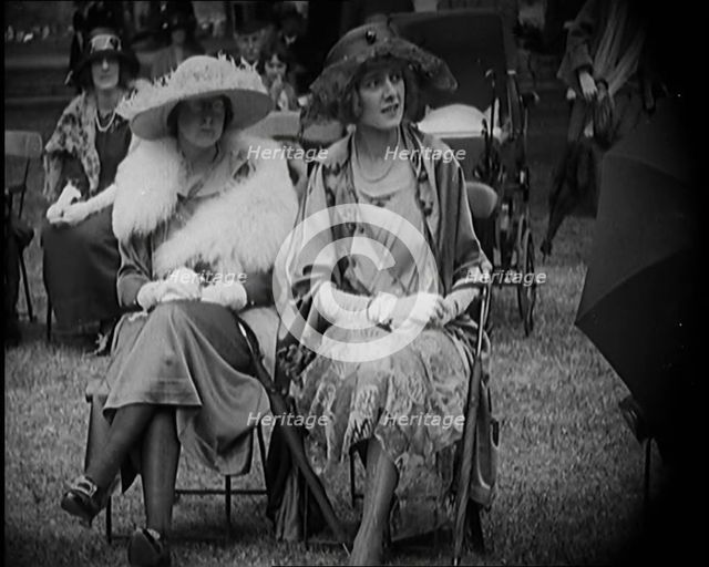 Three Female Civilians Seating Outdoors Wearing Evening Outfits and Hats, 1920. Creator: British Pathe Ltd.