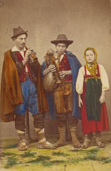 Three Italian peasants standing: two men playing wind instruments, a girl next to them, 1865-1875. Creator: Giorgio Conrad