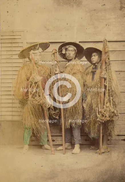 Three Japanese men in grass robes and wide-brimmed hats, 1868-1880. Creator: Felice Beato.
