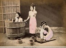 Three Japanese women washing: One in a wooden tub, one standing and one crouching..., c1890s. Creator: Unknown