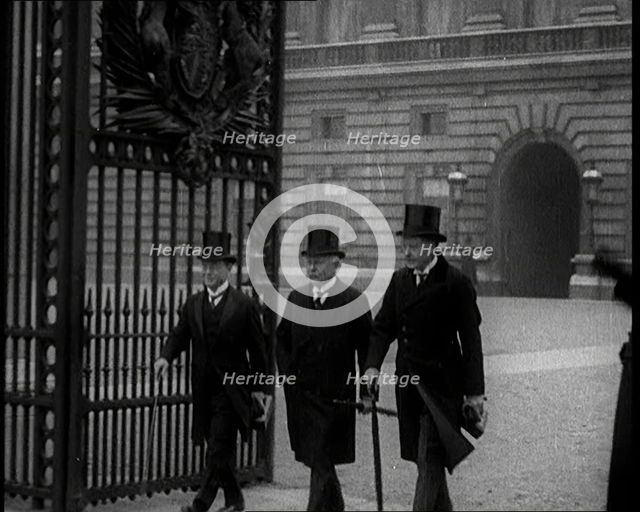 Three Male British Members of Parliament Walking Away from Buckingham Palace, Passing..., 1924. Creator: British Pathe Ltd.