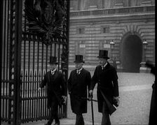Three Male British Members of Parliament Walking Away from Buckingham Palace, Passing..., 1924. Creator: British Pathe Ltd