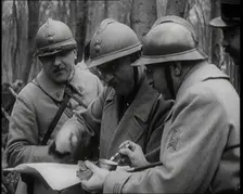 Three Male French Soldiers Standing in a Wood Looking at a Map, 1924. Creator: British Pathe Ltd