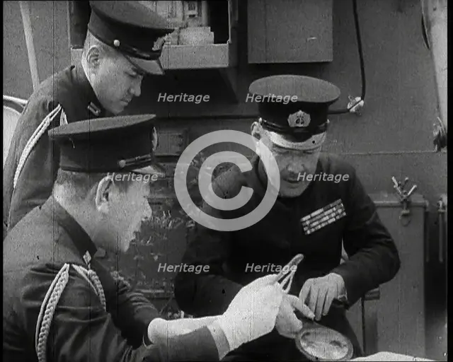 Three Male Japanese Naval Officers in Uniform Discuss Military Plans, 1937. Creator: British Pathe Ltd.