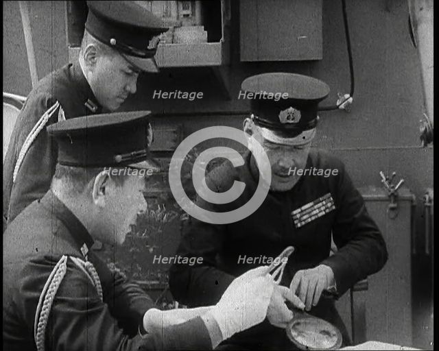 Three Male Japanese Naval Officers in Uniform Discuss Military Plans, 1937. Creator: British Pathe Ltd.