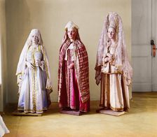 Three mannequins of women in elaborate dress, on wooden stands, between 1905 and 1915. Creator: Sergey Mikhaylovich Prokudin-Gorsky
