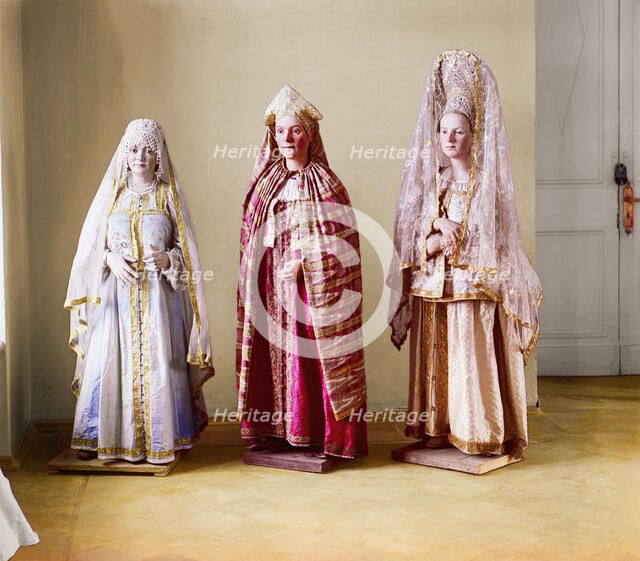 Three mannequins of women in elaborate dress, on wooden stands, between 1905 and 1915. Creator: Sergey Mikhaylovich Prokudin-Gorsky.