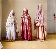 Three mannequins of women in elaborate dress, on wooden stands, between 1905 and 1915. Creator: Sergey Mikhaylovich Prokudin-Gorsky