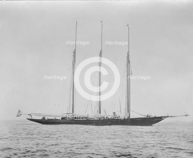 Three masted schooner at anchor. Creator: Kirk & Sons of Cowes.