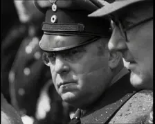 Three Men in a Crowd Listening to a Speech, 1930s. Creator: British Pathe Ltd
