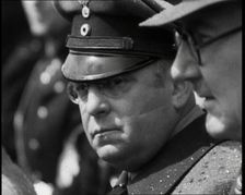 Three Men in a Crowd Listening to a Speech, 1930s. Creator: British Pathe Ltd