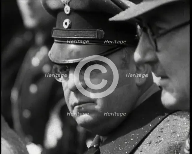 Three Men in a Crowd Listening to a Speech, 1930s. Creator: British Pathe Ltd.