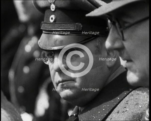 Three Men in a Crowd Listening to a Speech, 1930s. Creator: British Pathe Ltd.