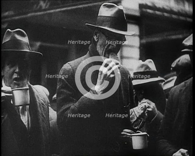 Three Men in the Foreground Drinking and Eating, 1933. Creator: British Pathe Ltd.