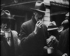 Three Men in the Foreground Drinking and Eating, 1933. Creator: British Pathe Ltd