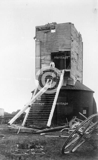 Three men standing on the remains of Golden Cross Windmill, Chiddingly, East Sussex, 1935.  Creator: HES Simmons.