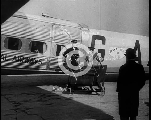 Three Men Tending to a Plane on the Ground, 1933. Creator: British Pathe Ltd.