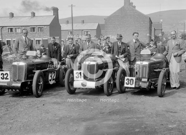 Three MG C type Midgets at the RAC TT Race, Ards Circuit, Belfast, 1932. Artist: Bill Brunell.