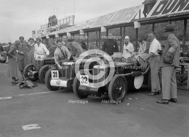 Three MG C type Midgets in the pits at the RAC TT Race, Ards Circuit, Belfast, 1932. Artist: Bill Brunell.
