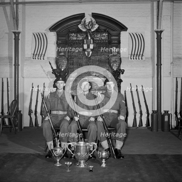 Three soldiers are posed in front of the Honourable Artillery Company's war memorial, c1945-c1965. Artist: SW Rawlings