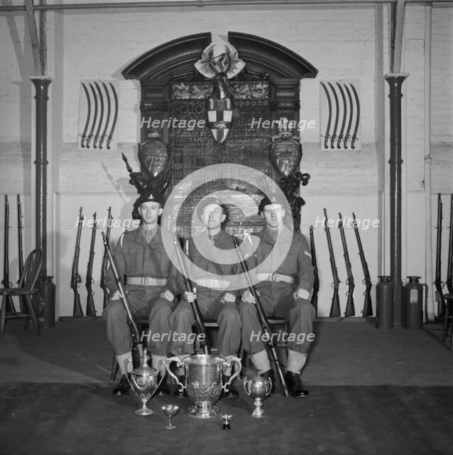 Three soldiers are posed in front of the Honourable Artillery Company's war memorial, c1945-c1965. Artist: SW Rawlings