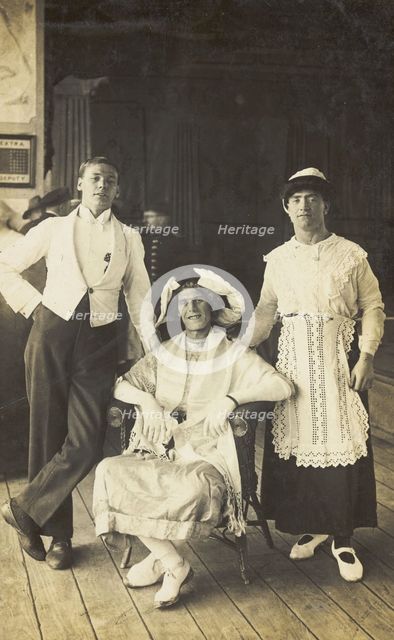 Three soldiers, two in drag, pose in costume, c1920. Creator: Unknown.