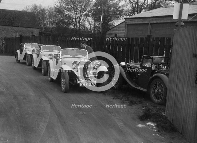 Three Singer cars and a MG PA at a motoring trial, 1930s. Artist: Bill Brunell.