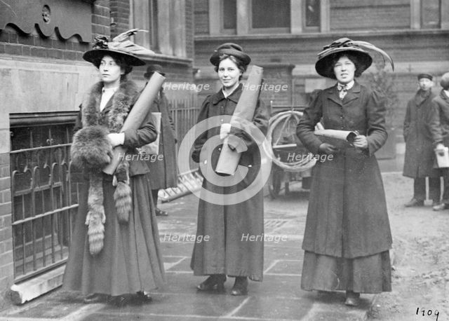 Three suffragettes prepare to chain themselves to the railings, 1909. Creator: Unknown.