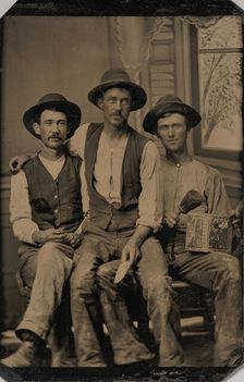 Three Painters, with Brushes and a Can of Paint, in Front of a Painted Window Backdrop, 1870s-80s. Creator: Unknown