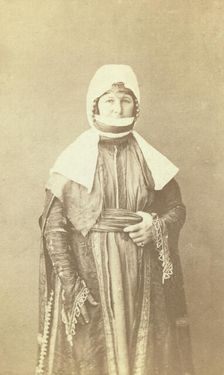 Three-quarter length portrait of woman, facing front, between 1870 and 1886. Creator: Unknown