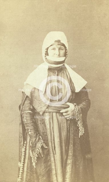 Three-quarter length portrait of woman, facing front, between 1870 and 1886. Creator: Unknown.