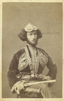 Three-quarter portrait of man, seated, facing right, between 1870 and 1886. Creator: Unknown