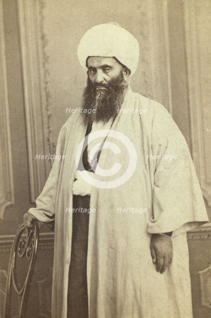 Three-quarters length portrait of a mullah(?), facing left, between 1870 and 1886. Creator: Unknown.