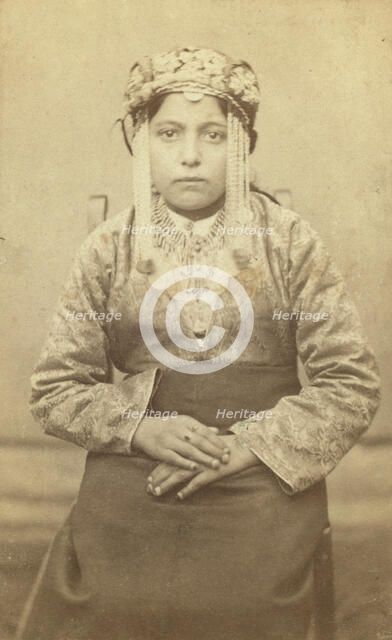 Three-quarters length portrait of a woman, seated, facing front, between 1870 and 1886. Creator: Unknown.